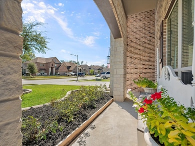 Built with the Premium Stone & Brick Elevation, relax on the covered Front Patio adorned with an 8' Mahogany Wood Front Door.