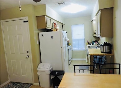 Kitchen featuring freestanding refrigerator, light