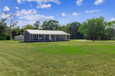 View of front of house with a front lawn, a metal