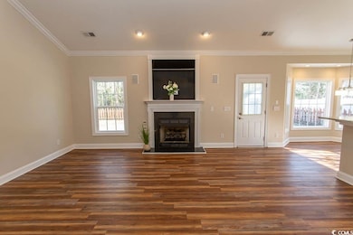 Unfurnished living room featuring dark wood-type f