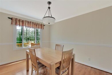Formal dining room with wood floor, crown molding,