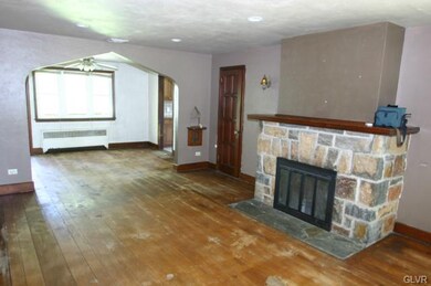 Living room w/ stone fireplace
