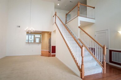 Wood floors in the entry wraps around to right sid