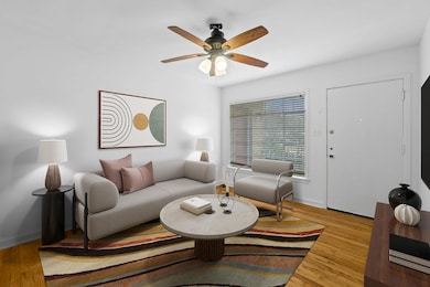 Living room with a ceiling fan, wood finished flo