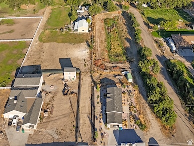 Aerial view of property and surrounding area with a mountain backdrop and nearby suburban area