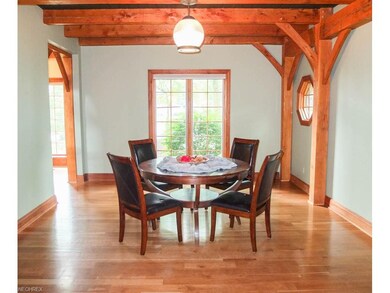 Formal dining room with exposed wood beams.