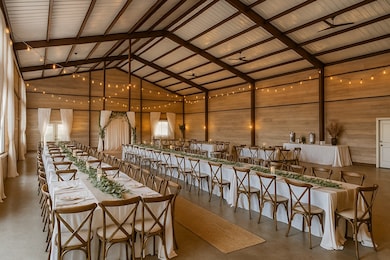 Dining space featuring high vaulted ceiling, finished concrete flooring, and wood walls