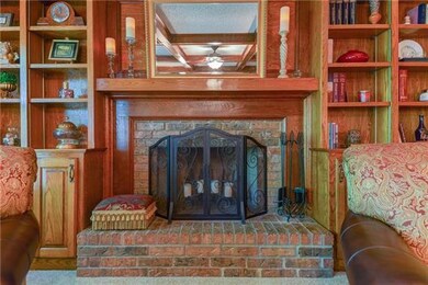Masonry fireplace with gas starter is flanked by g