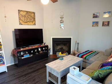 Living room featuring wood finished floors, a cei