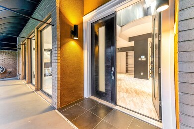 This inviting entryway features a modern glass doo