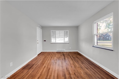 Spare room with wood finished floors and baseboards