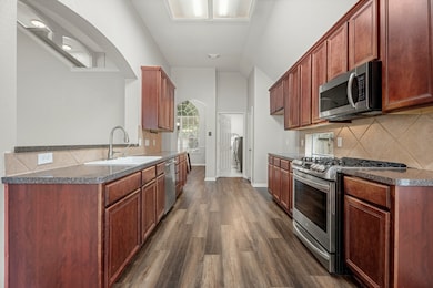 Kitchen with view of the laundry room and formal dining room/flex space.