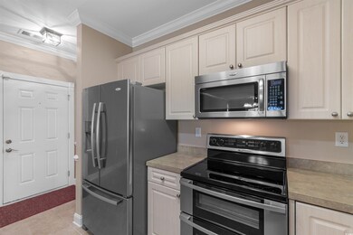 Kitchen with light tile patterned floors, light co