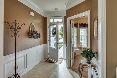 A bright and welcoming foyer with glass and transom front door. The front bedroom is perfect as a guest room or an office.