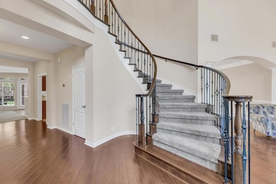 Stairs featuring arched walkways, a high ceiling,