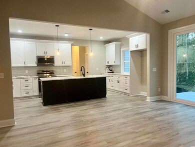 Kitchen featuring white cabinets, light hardwood /