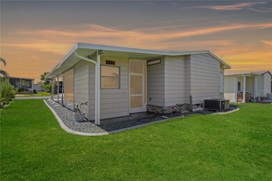 The rear of the home offers a comfortable screened porch and a quiet, landscaped yard ideal for outdoor enjoyment.