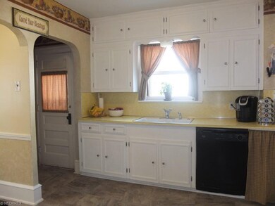 Kitchen has spice cabinet and pantry.