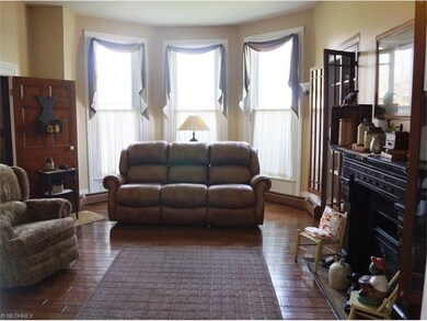 LIBRARY / SITTING ROOM WITH LOTS OF NATURAL LIGHT.