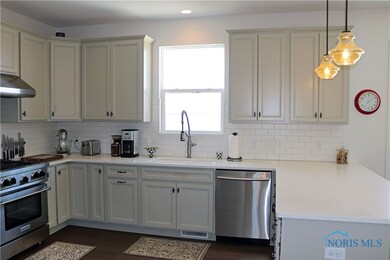 Custom painted cabinetry is graced with a classic