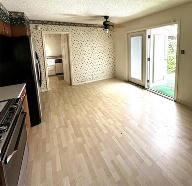 Kitchen with light wood-type flooring, stainless s