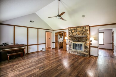 Living room with high vaulted ceiling, a fireplace