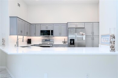 Kitchen with tile patterned flooring, gray cabinet