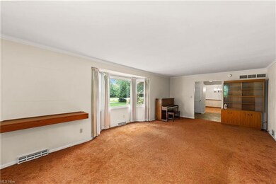 Living room with a built-in and picture window ove