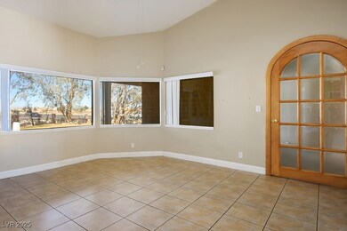 Unfurnished room featuring lofted ceiling, light t