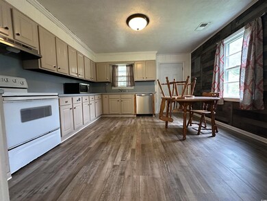 Kitchen with wooden walls, dark hardwood / wood-st