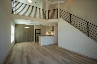 Unfurnished living room featuring a sink, light w
