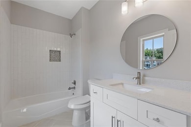 Full bathroom featuring tile patterned floors, van