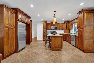 Updated kitchen with wood cabinets, granite counte