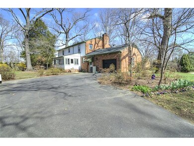 Plenty of parking, a garage, and numerous plantings.