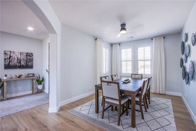 Dining area featuring arched walkways, light wood-
