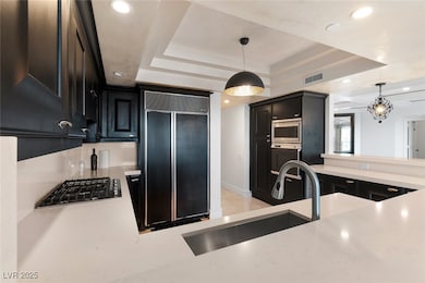 Kitchen featuring built in appliances, a raised ce
