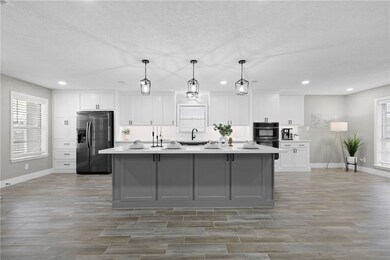Kitchen featuring white cabinets, light countertop