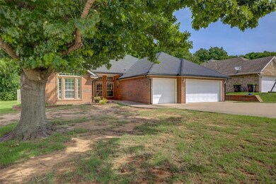 View of front of home featuring a garage, driveway, brick siding, roof with shingles, and a front lawn