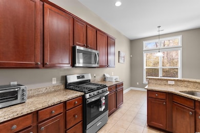 Kitchen featuring light tile patterned floors, lig