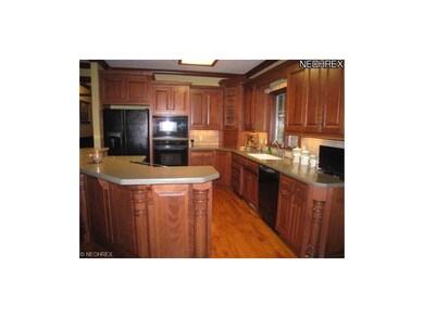Kitchen has island with breakfast bar.