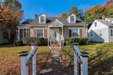 Cape cod-style house with a front yard