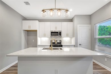 Brushed gold finishes on handles, faucets, & light