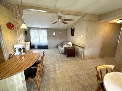Carpeted dining space featuring visible vents, a c
