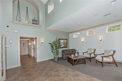 Sitting room with a towering ceiling and tile floo
