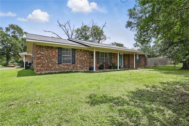 Single story home with brick siding and covered po