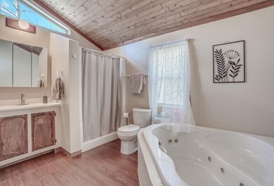 Off the dining room is the full bath with walk in shower and soaker tub