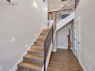 Stairway with visible vents, baseboards, and wood finished floors