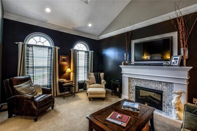 Cuddle up by the fireplace in the inviting living 