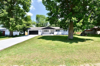 single story home featuring an attached garage and driveway