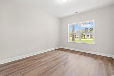Unfurnished room featuring wood finished floors and baseboards